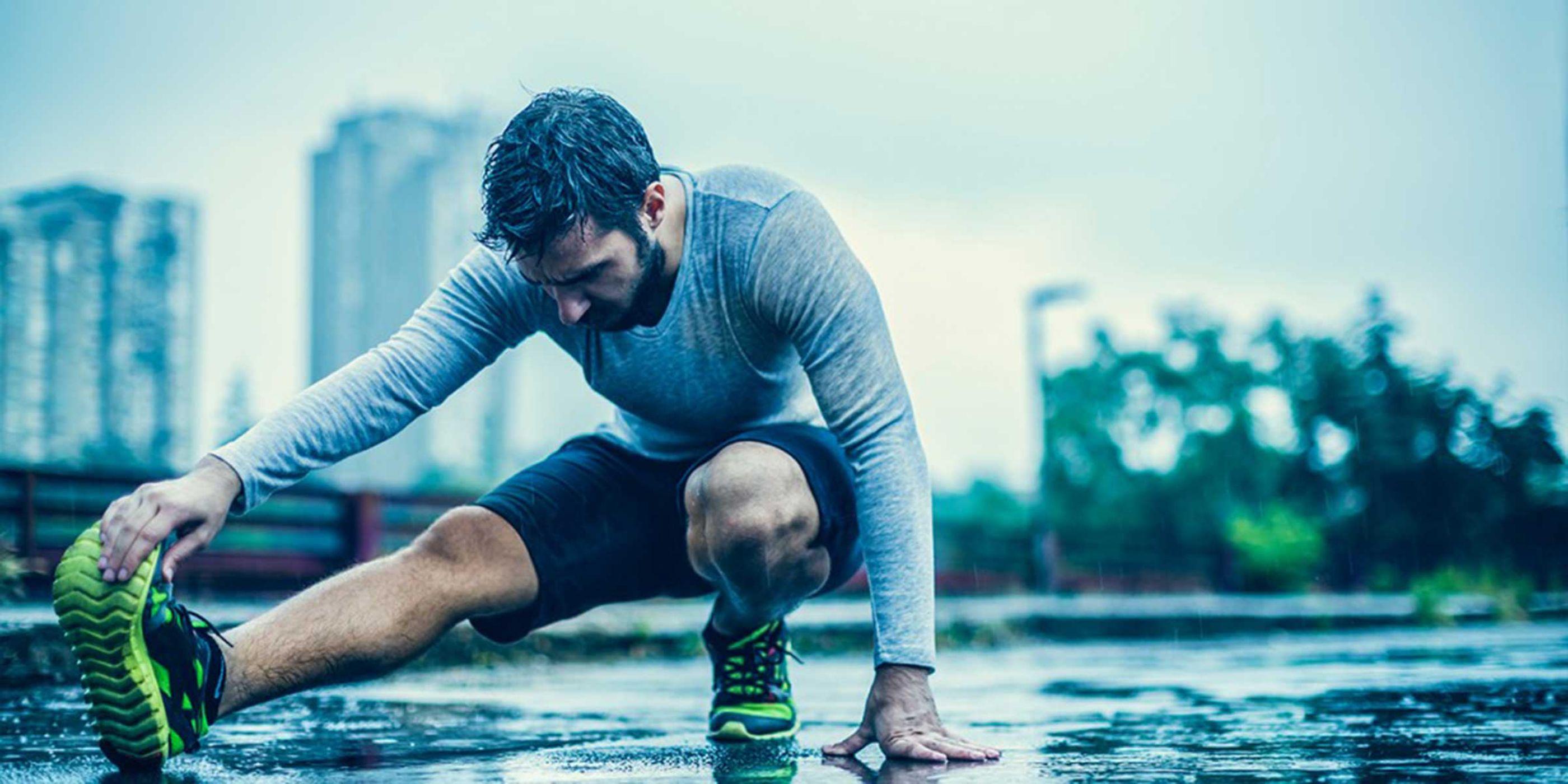 Person stretching on wet surface